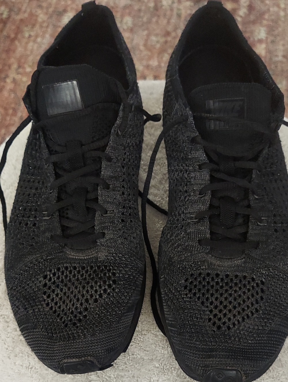 Nike Men’s FlyKnit Racer Triple Black Athletic Shoes